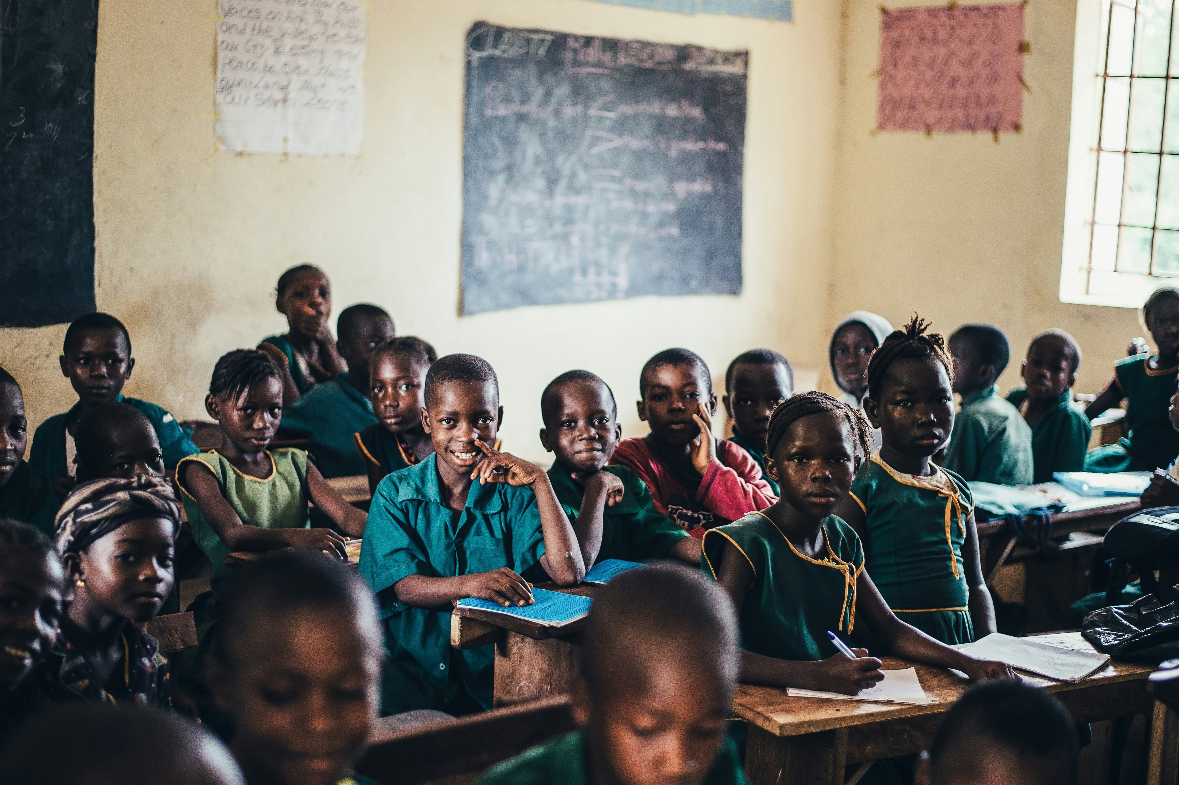 Primary school students learning in classroom desks